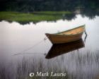 Rowboat - photo of a rowboat floating on calm waters and the shore reflecting in the water.