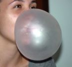 Woman Blowing a Bubble - Woman blowing a bubble with her bubble gum.