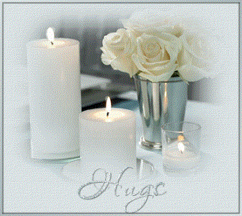 Hello from Kentucky,USA - This is a photo of white roses and flowers and vases and multiple candles in different sizes and everything is white and silver very nice. with teh word hugs in silver on the bottom.