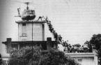 Fall of Saigon - Shows a helicopter on top of the US Embassy in Saigon and people scrambling up a ladder to get aboard Fall of Saigon - Shows a helicopter on top of the US Embassy in Saigon and people scrambling up a ladder to get aboard