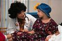 Leukemia - photo of child in hospital bed wearing a heart and talking to a doctor. Leukemia - photo of child in hospital bed wearing a heart and talking to a doctor.