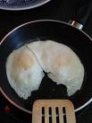 om eggs - over medium eggs frying in a pan
