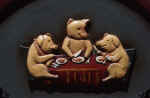 Three Pigs at Lunch - Three pigs eating a lunch togeter, sitting at the table.

http://www.bigfoto.com/miscellaneous/photos-02/