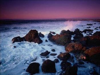 Beautiful beach - Here&#039;s a beautiful photo of some waves crashing onto the rocks at a beach during a sunset.