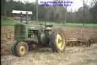 a green tractor - dare I call it a John Deer they usually are green.  a great tool on the farm for hauling a wagon, clearing a driveway and plowing.