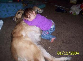 My daughter and my dog - My dog Sable taking it easy as my daughter climbs on her.