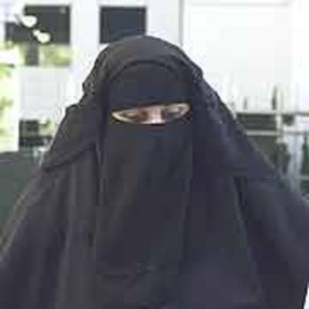 A woman in veil - In some countries it is compulsory to be covered like this, irrespective of the weather. A woman in veil - In some countries it is compulsory to be covered like this, irrespective of the weather.