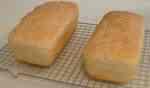 bread cooling on wire racks - bread fresh from the oven is the favorite smell I answered this discussion with, these loves sitting on wire racks are cooling