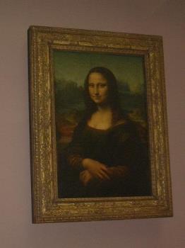 A picture i took of the MONA LISA - The mona lisa, this picture does not do her justice i took it on my old digital cam, Le Louvre has not got the best of lighting.