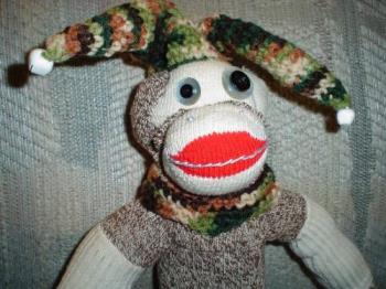 Jester monkey close up - I made this monkey and crocheted the hat and made the gourd swing and the crocheted pillow he&#039;s sitting on.