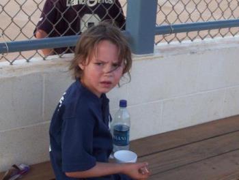 my daughter now 7 - my daughter in her softball out fit. Waiting to play.