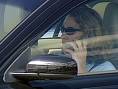 mobile car driving - This photo shows the driver of A car with a mobile in her hand 