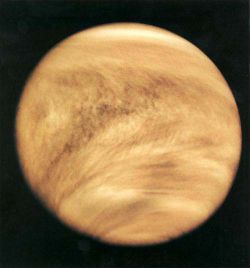 Venus - Venus (0.7 AU) is of comparable mass to the Earth (0.815 Earth masses), and, like Earth, possesses a thick silicate mantle around an iron core, as well as a substantial atmosphere and evidence of internal geological activity, such as volcanoes. However, it is much drier than Earth and its atmosphere is 90 times as dense. Venus has no natural satellite. It is the hottest planet, with surface temperatures over 400 °C, most likely due to the amount of greenhouse gases in the atmosphere. Although no definitive evidence of current geological activity has yet been detected on Venus, its substantial atmosphere and lack of a magnetic field to protect it from depletion by the solar wind suggest that it must be regularly replenished by volcanic eruptions.