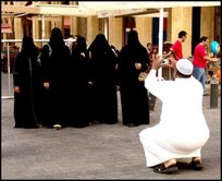 man taking photos of ladies in veil - man taking photos of ladies in veil