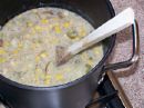 Corn Chowder - photo of a pan full of corn chowder, a soup made with fresh milk, evaporated milk, cubed potatoes, cream style corn, corn niblets, onions and salt pork.