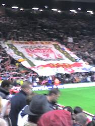 The Kop - The kop at anfield with the flag going up.