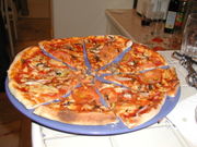 pizza - A pizza with tomato sauce, cheese, tomatoes, field mushrooms, onion