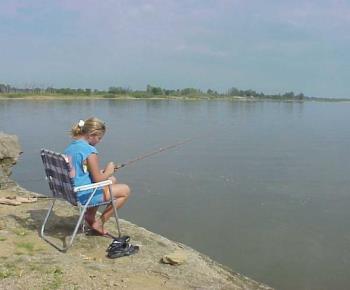 fishing - Girl sitting on the lake fishing.