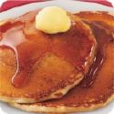 Pancakes - photo of a stack of pancakes with maple syrup and butter.