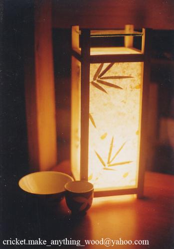 my margarita lamp - This is the first lamp I made with this type of frame and this paper. I chose this paper since for the size of the lamp, it would show the design and texture of the paper, even when unlit. There is a piece of glass on the top of the lamp for small items. I used pinewood for the frame, and it stands at 16'. It has a 40-W bulb, to give a soft glow to the whole height of the lamp, suitable on a table top or as an accent light in a corner of a room.