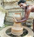 Something like this?????????????? - This is a potter making a pot out of mud this is how he makes his living.