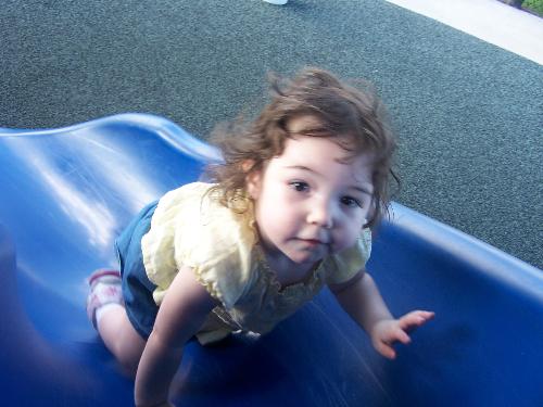 A day at the park - This is a picture of my youngest daughter enjoying herself at the park. We always have a lot of fun there.  She really loves the slide. Just one of the quieter momemts in Orlando.