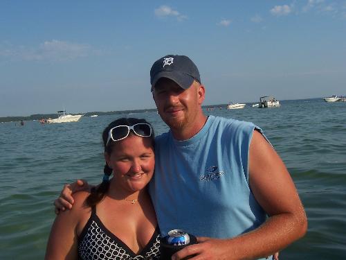 The Mavis's - My husband Josh and I on our boat over the 4th of July last year