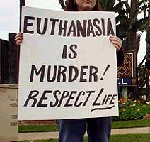 Euthanasia-Mercy killing - This is a girl with a poster condeming euthanasia, or mercy killing.