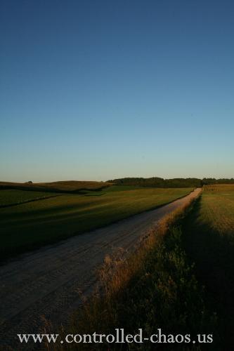 Country Road - Rolling hills, blue sky and a dirt road at sunset.  Wexford county, Michigan.  September, 2006.