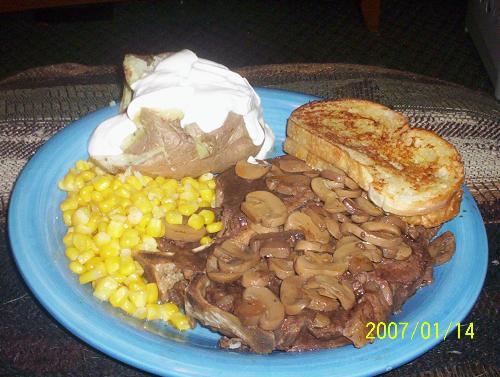 Anniversary dinner - Porterhouse steak covered in mushrooms (slow cooked in A-1), Baked potato with real butter & sour cream, Fried corn, Garlic toast.