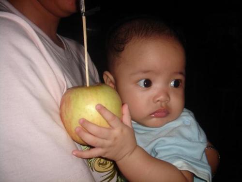 Randall Kyle - This is a picture of our adorable baby boy. It was taken at my grandma's house where we are having the traditional family gathering. He likes them apple so much! hehehe