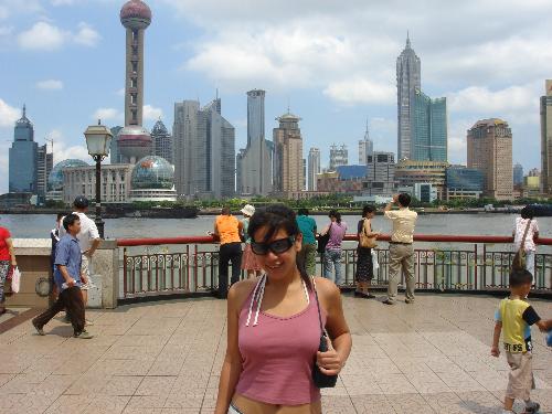 Shanghaied - Shanghai is one of the most populated cities in the world! This pic was taken on The Bund - Shanghai's Riverfront Esplanade on the older part of the city, Pu Xi. Behind me is the view of Shanghai's modern skyline. I hear that the view's better at night. Jin Mao tower behind me..the phallic looking needle with balls. Don't know wht does Jin Mao mean, but to me it sounds a lot like Gold Hair. Obviously my command of mandarin isn't that great ;)