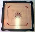 carrom - this is the image of carrom with coins.it has 9 white 9 black and one red coin.