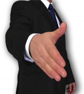 Businessman extending hand - A picture of a business man offering a virtual handshake. His hand is extended to the viewer. He is wearing a suit and tie - professional attire.  A royalty-free stock photo from StockXchange, www.sxc.hu