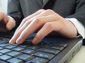 Businessman typing on notepad - A picture of a businessman in a suit and tie typing on a notepad computer. His body language suggests that he is hard at work. I like to imagine that he is writing a business blog.

A royalty-free photo from Stock Xchange, www.sxc.hu