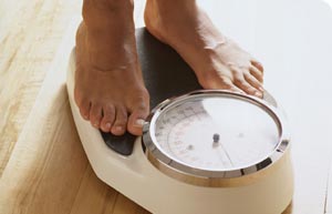 Feet on Scales - A person standing on scales, most likely weighing themselves or posing for this photo.