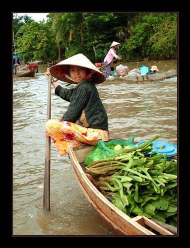 Small girl on the Mekong - A young girl was paddling along the Mekong, and gave us the warmest of smiles.