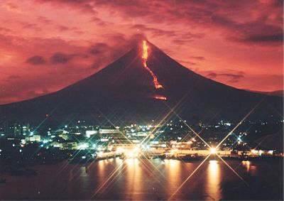 Mt. mayon Erupting - Mayon Volcano erupting at night with Legazpi City in the background.