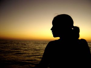 Profile silhouette - A picture of a young lady in front of the horizon at sunset. The focus is on a silhouette of her profile. Very rich colors and calming effect.

A royalty-free photo from Stock Xchange, www.sxc.hu