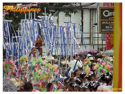 Sinulog - This shows the contingent dancing in the streets. There is an image of the Sto. Niño being held aloft. Sinulog - This shows the contingent dancing in the streets. There is an image of the Sto. Niño being held aloft.