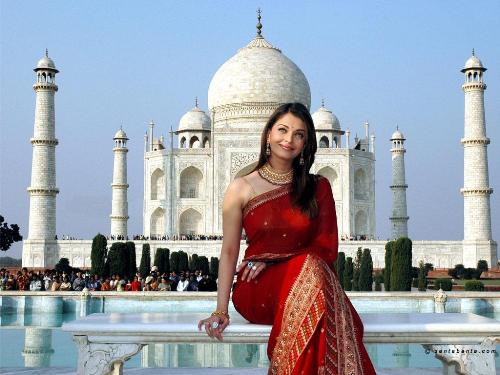 Beauty sitting in front of another beauty - Aishwarya rai....sitting...smiling....near....1 of the wonders of the world....Taj mahal