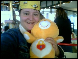 Secret-Bear from the Care-Bear family - This is me and my constant companion Secret-Bear.  Where i go, she goes.  We are at the carasell on the 4th floor of the New York State Museum in Albany, NY where my mom has her paintings/illustrations hanging.
