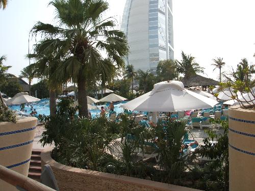 dubai, uae - Beating the summer heat at jumeirah beach in Dubai, UAE. The Burj's base is seen at the background.