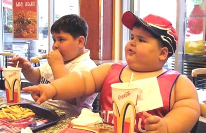 Overweight children - Overweight children eating at fast food chain McDonalds