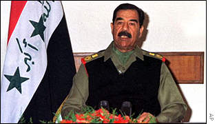 Saddam Hussein the ex-President of Iraq - Saddam Hussein beside the national flag of Iraq.