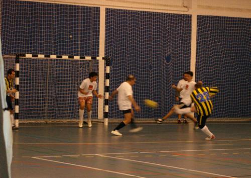 Playing futsal  - Me scoring a goal, and there´s a older man.