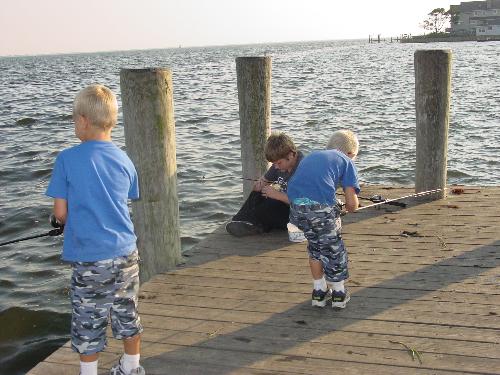 3 on a dock - This is my 3 children.  The oldest is baiting his hook, the youngest is untangling his line and the middle one is actually fishing!