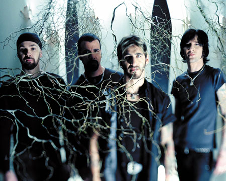 Godsmack just keeps on banging your head -  The Boston-based alternative metal group Godsmack originally comprised vocalist Sully Erna (a devout Wiccan), guitarist Tony Rambola, bassist Robbie Merrill, and drummer Tommy Stewart. After debuting in 1997 with All Wound Up, Godsmack signed with Universal, which in 1998 reissued the LP as a self-titled effort with a handful of new tracks; at that point Stewart -- who'd left the group in mid-1997 and was replaced by drummer Joe d'Arco -- returned to the lineup on a permanent basis. The band's audience built slowly but surely, and Godsmack was certified gold in 1999, the same year the group was invited to join the Ozzfest tour; by the next year, it had sold over three million copies, thanks to hit singles like 'Whatever' and 'Keep Away.' In 2000, the group again played Ozzfest, and released their second proper album, Awake, that fall. In January 2001, Awake earned the band a Grammy nomination for Best Rock Instrumental Performance for the song 'Vampires,' and by March, it had sold two million copies. Hot on the heels of their continuing success, their single 'I Stand Alone' propelled the hype of the movie The Scorpion King in March 2002. As the single maintained Godsmack's strong presence at modern rock radio into the summer, founding member Tommy Stewart left the band in June. The David Bottrill-produced (Peter Gabriel, Tool, Mudvayne) album Faceless appeared in April 2003. It also marked the debut of ex-Amen drummer Shannon Larkin. The all-acoustic Other Side arrived in spring 2004. In 2006, Erna stepped behind the board to helm IV, a collection of new material that reached number one while both retaining the group's trademark heft and expanding their sonic palette.