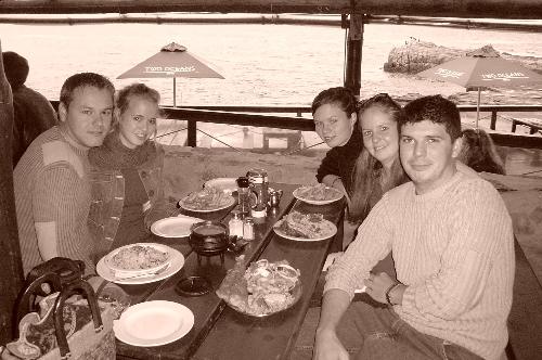 hermanus whale watching - my friends and i at a restaurant in Hermanus Cape Town, South Africa watching for whales.  the area is frequented every October/November being enormous scores of whales, there is also a famous whale caller, who with his 'blow-horn' resonates a sound that the whales seem to respond to this is tradition and secret handed down by one whale 'caller' to another from generation to generation