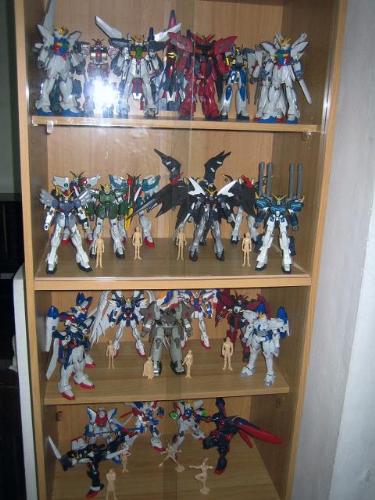 my gundams - this one is a group pictures of my gundams, i have placed them in a cabinet with glass doors, so that visitors can see my collection weather they go in my room...the pic is consist of my gundam 1/100& 1/144 scale collection from the gundam series Gundam X(upper row), Gundam WIng Endless Waltz (3rd and 2nd Row) and Gundam G (lower row) my other gundams such as the perfect grades and V Gundams are placed on my other cabinet... i wish i can post the other pics, but i thiunk i can only post one... i hope you like the pics!